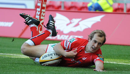 Scarlets winger Lee Williams dives over for a first half try