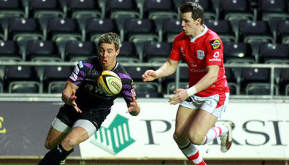 Ospreys scrum half Rhys Webb deals with a loose ball
