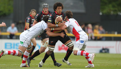 The Dragons' Toby Faletau is tackled by Ulster's Pedrie Wannenburg and Robbie Diack